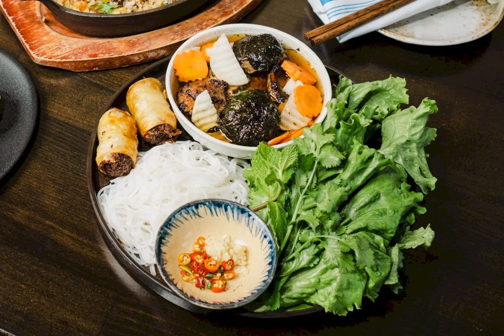 Tasty bun cha with grilled pork, soft noodles, and aromatic herbs